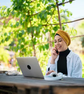 Frau beim Online-Seminar des TourismusHub in einem Garten